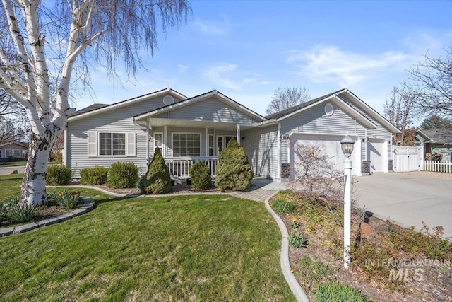 ranch-style home featuring an attached garage, covered porch, fence, concrete driveway, and a front lawn