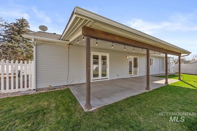 back of property featuring a patio area, fence, and a lawn
