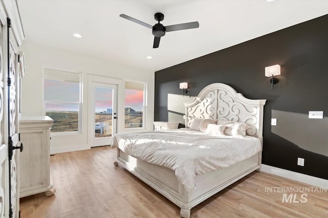 bedroom with light hardwood / wood-style floors and ceiling fan