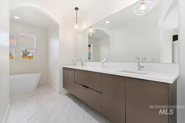 bathroom with vanity and a bathtub