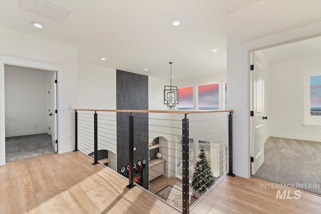 hallway featuring a chandelier and hardwood / wood-style floors