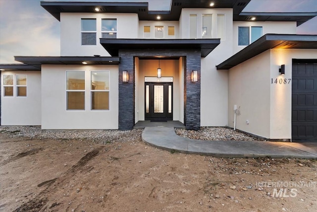 view of exterior entry featuring a garage