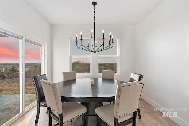 dining room featuring a chandelier and light hardwood / wood-style flooring