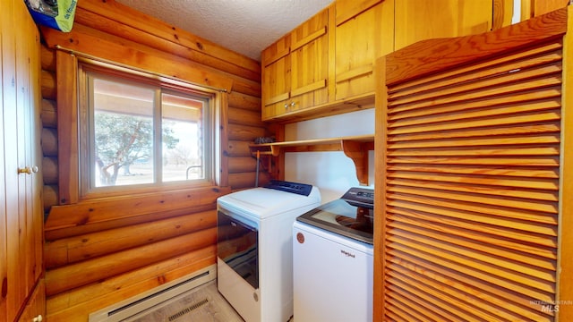 clothes washing area with a baseboard heating unit, cabinet space, a textured ceiling, and washing machine and clothes dryer