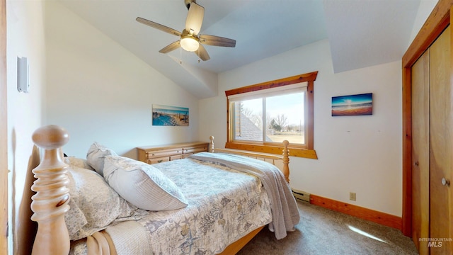 bedroom with a closet, carpet flooring, baseboards, baseboard heating, and vaulted ceiling