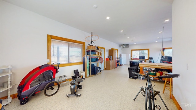 exercise room with recessed lighting and baseboards