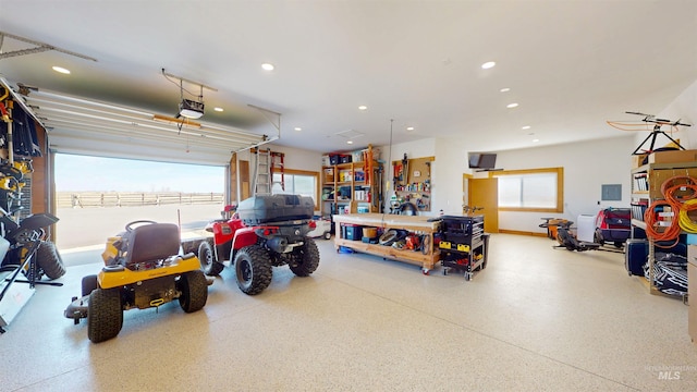 garage with recessed lighting, a garage door opener, and baseboards