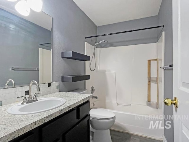 full bathroom with shower / bathtub combination, backsplash, wood-type flooring, vanity, and toilet