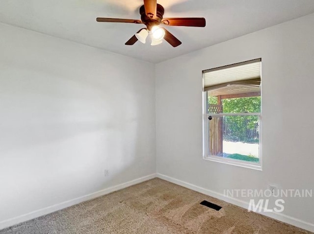 spare room with ceiling fan and carpet floors