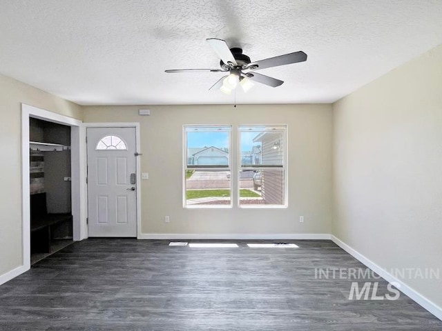 foyer with a textured ceiling, dark hardwood / wood-style floors, and ceiling fan