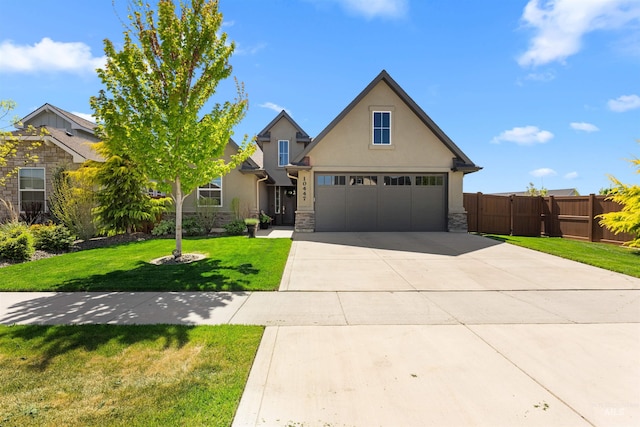view of front facade with fence, a front lawn, stone siding, stucco siding, and driveway