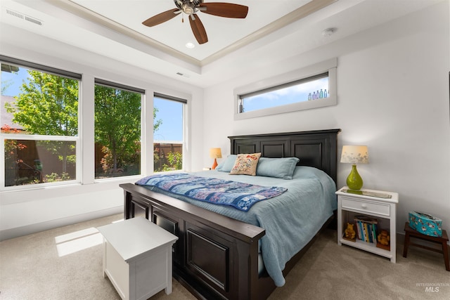 carpeted bedroom with visible vents, recessed lighting, a raised ceiling, and a ceiling fan