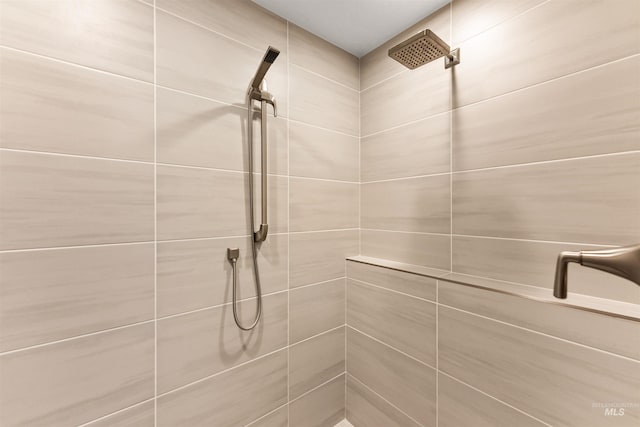 bathroom with a tile shower