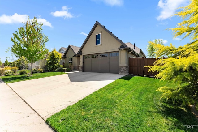 traditional-style house with fence, stone siding, a garage, stucco siding, and driveway