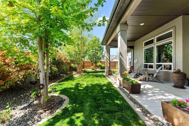 view of yard featuring a patio and a fenced backyard