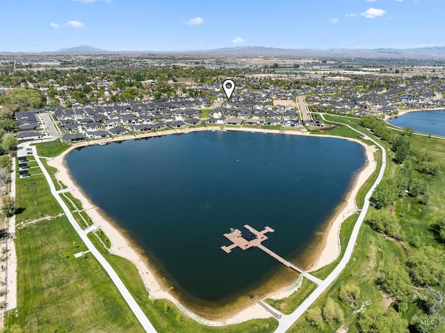 drone / aerial view featuring a residential view and a water and mountain view
