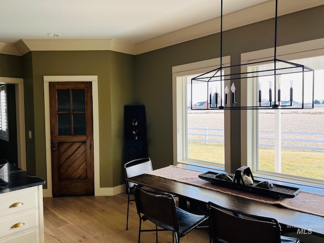 dining space featuring an inviting chandelier and light hardwood / wood-style flooring