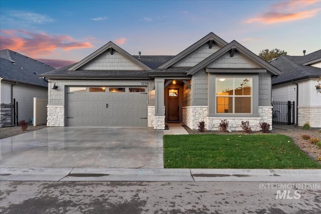 craftsman house with a garage and a lawn