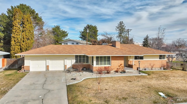 ranch-style house with driveway, brick siding, fence, and a front yard