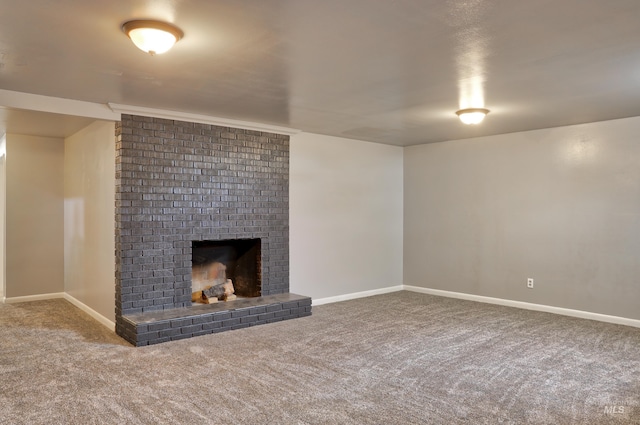 unfurnished living room with baseboards, a fireplace, and carpet