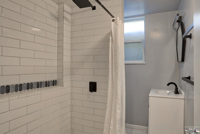 full bath featuring tiled shower and vanity