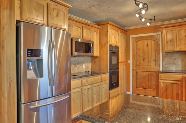 kitchen featuring dark stone countertops, a textured ceiling, decorative backsplash, black appliances, and ornamental molding