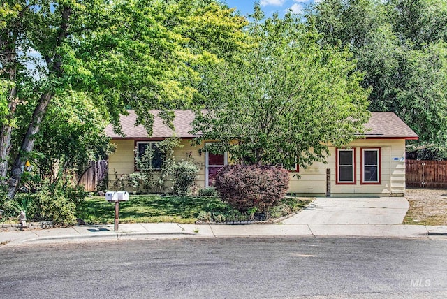 obstructed view of property featuring a front lawn