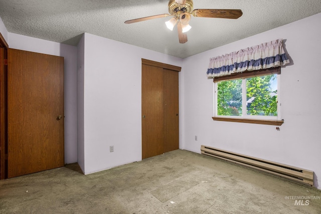 unfurnished bedroom featuring a baseboard heating unit, a textured ceiling, carpet, a closet, and ceiling fan