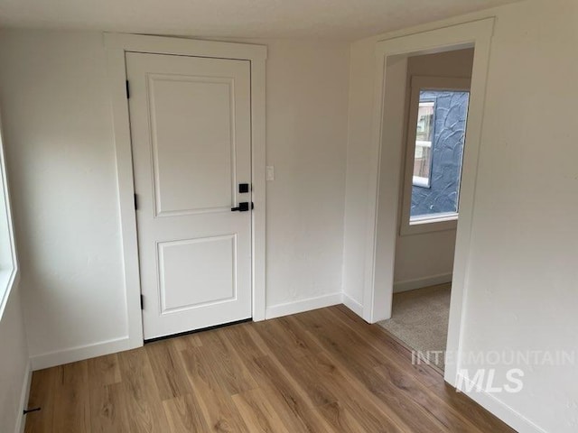 interior space featuring wood finished floors and baseboards