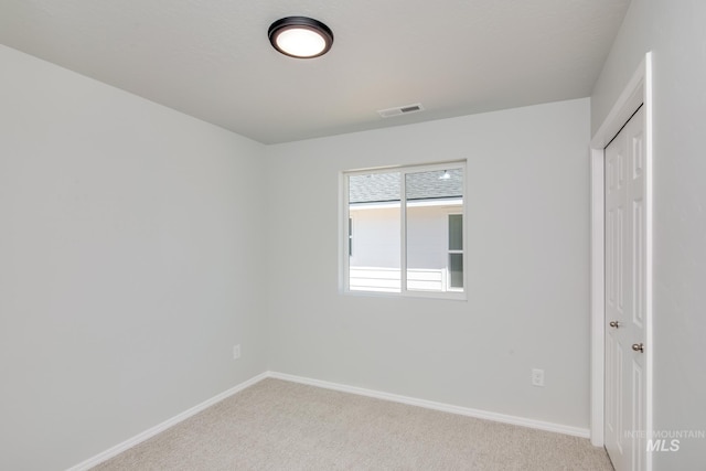 interior space featuring a closet and light colored carpet