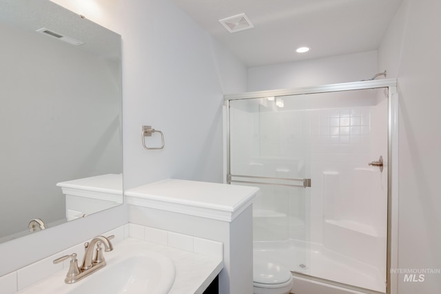 bathroom with vanity, an enclosed shower, and toilet