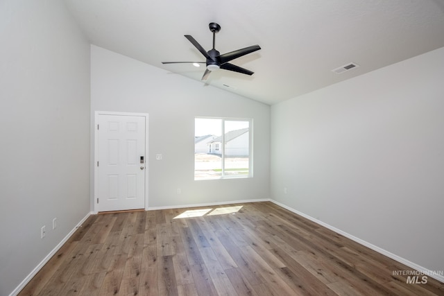 spare room featuring ceiling fan, lofted ceiling, and light hardwood / wood-style floors