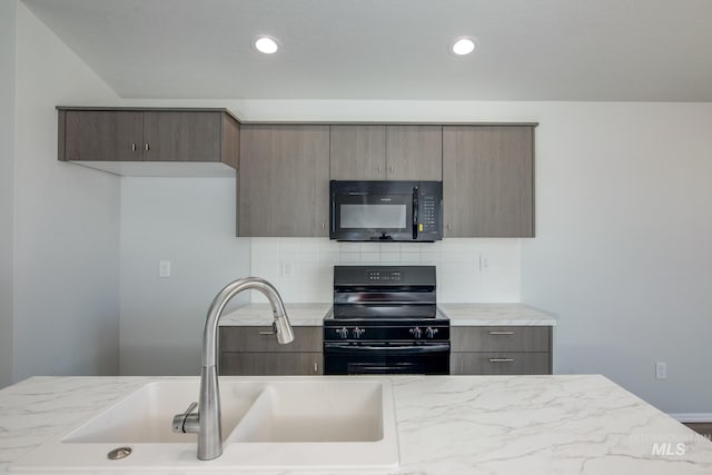 kitchen with black appliances, sink, light stone counters, and tasteful backsplash