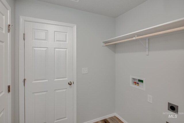 washroom with wood-type flooring, hookup for an electric dryer, and washer hookup