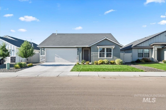 ranch-style home featuring a front yard and a garage