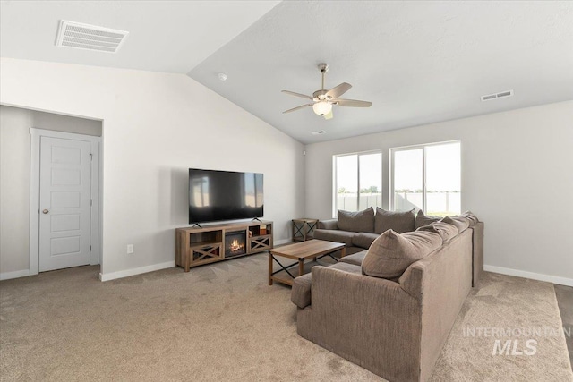 carpeted living room featuring ceiling fan and lofted ceiling