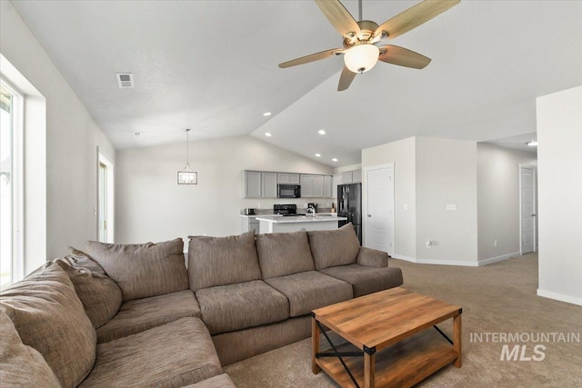 carpeted living room featuring ceiling fan and lofted ceiling