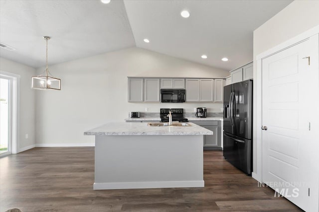 kitchen featuring gray cabinetry, sink, hanging light fixtures, an island with sink, and black appliances