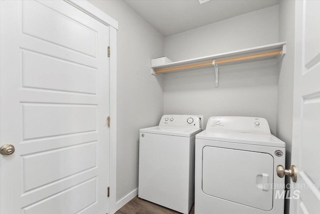 washroom with dark hardwood / wood-style flooring and independent washer and dryer