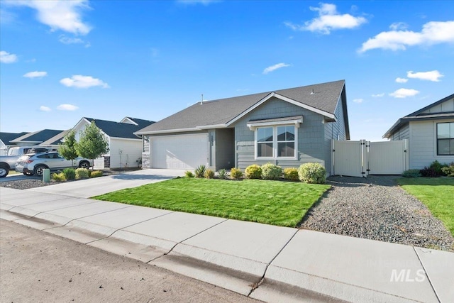 view of front of property featuring a front lawn and a garage