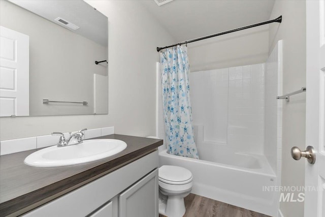 full bathroom featuring shower / tub combo, vanity, hardwood / wood-style flooring, and toilet