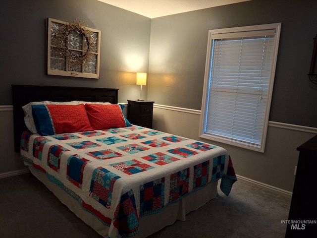 carpeted bedroom featuring baseboards