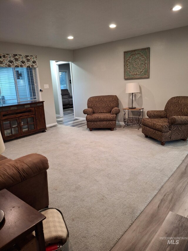 living room with recessed lighting, wood finished floors, and baseboards