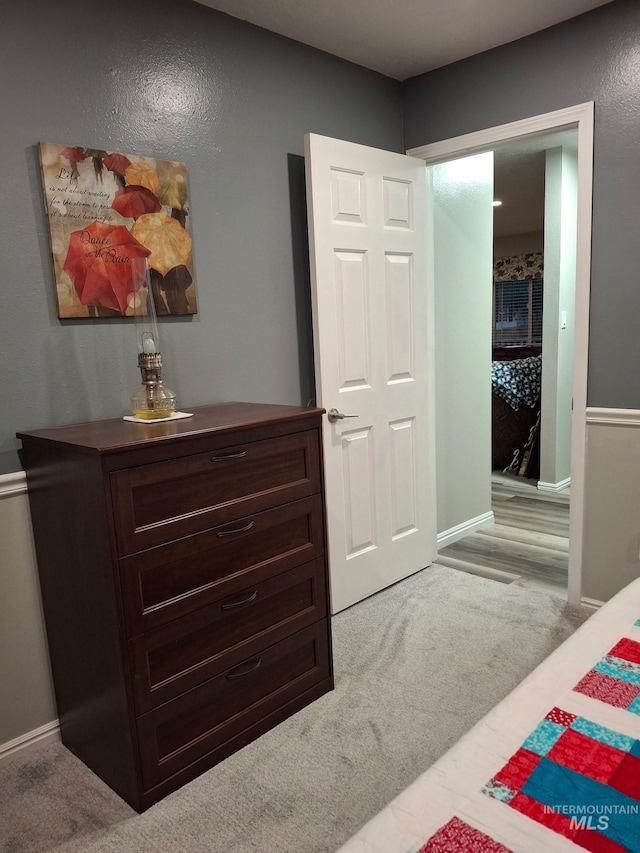 carpeted bedroom featuring baseboards