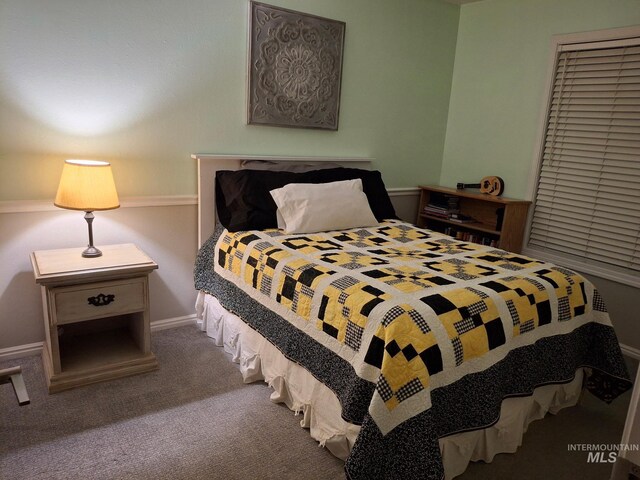 carpeted bedroom featuring baseboards