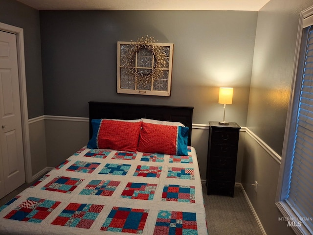 bedroom featuring carpet floors and baseboards