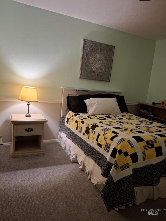 bedroom featuring carpet floors and baseboards