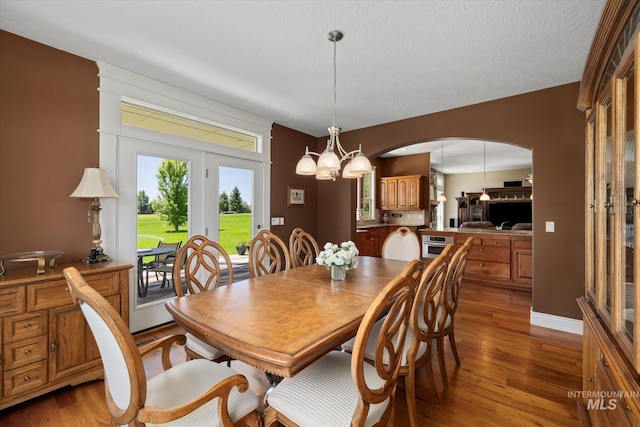 8585 W Rioja St, Star, ID 83669 - dining space featuring arched walkways, light wood-style flooring, and a chandelier