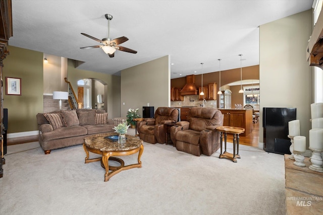 8585 W Rioja St, Star, ID 83669 - living area featuring arched walkways, ceiling fan, baseboards, and carpet floors