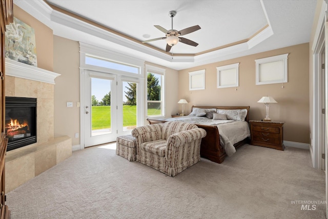 8585 W Rioja St, Star, ID 83669 - bedroom featuring access to outside, a tray ceiling, light carpet, a tile fireplace, and multiple windows